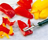 Close-up of pepper skin being removed with vegetable peeler