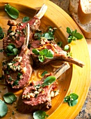 Close-up of rack of lambs with watercress on plate