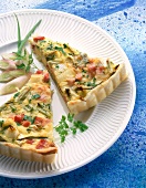 Close-up of spring onion quiche with parsley on plate