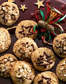 Close-up of oatmeal cookies with chocolate designs and hazelnuts