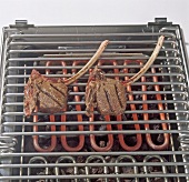 Mouflon chops being grilled on barbecue