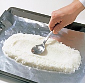 Close-up of salt being spread for preparing mufflonrucken, step 3