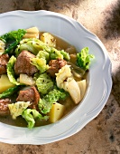 Close-up of savoy cabbage stew with lamb in bowl