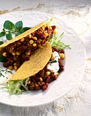 Close-up of tacos with mince and vegetable filling on plate