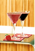 Two cocktails in martini glasses with strawberry