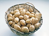Close-up of potatoes in basket on white background