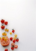 Yellow, red cherry tomatoes and beefsteak tomatoes on white background