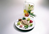 Boiled beef with chive vinaigrette and salad wreath on plate