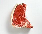 Close-up of raw beef steak on white background