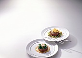 Beef hamburger with potato rosette and Chinois vegetables on two plates