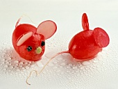 Two radish mice on white background with water drops on it