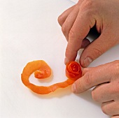 Close-up of tomato peels being decorated, step 2