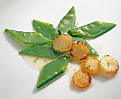 Mangetout and artichoke salad on white background