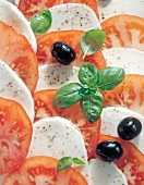 Close-up of sliced ??tomatoes with mozzarella and olives