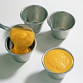 Carrot puree mix being put in ramekins, step 2