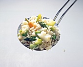 Close-up of glazed vegetables with rice on a trowel