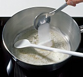 Adding sugar and salt to foam of butter in saucepan, step 1
