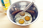 Egg yolk with salt and whisk in bowl for preparing pasta, step 1