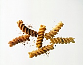 Close-up of fried spiral noodles on white background