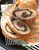 Close-up of slice of roast turkey roll with Swiss chard on plate