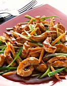 Close-up of turkey with carrots and leeks on red plate