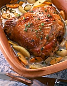Close-up of turkey thigh with apples and carrots