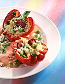 Close-up of stuffed pepper with rice and green peas on plate