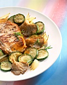 Close-up of veal chops with courgettes on dish
