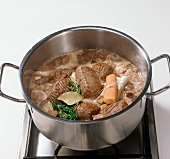 Beef bourguignon being cooked in pot, step 9