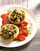 Onions stuffed with minced pork and garlic with tomatoes sauce on plate