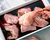 Rabbit's meat being marinated with herbs