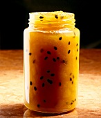 Peach and passion fruit yellow jam in glass jar
