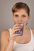 Portrait of woman drinking glass of water