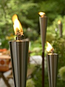 Close-up of lit metal torches