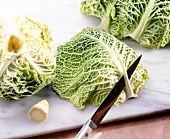 Kale leaves being cut with knife