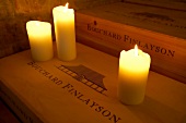 Three lit candles on wine box in Bouchard Finlayson Winery, South Africa