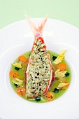 Red mullet fillet with olive crust and mozzarella on plate