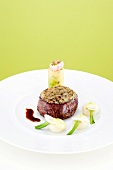 Fillet steak with shallots, truffle crust and leek cannelloni on plate