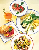 Variety of dishes with crisp bread, tomato juice, potato salad and asparagus