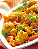 Close-up of cauliflower curry with carrots and parsley in serving tray