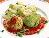 Chinese cabbage meatballs with tomato sauce and herb on plate