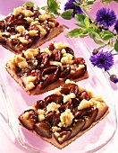Slices of plum cakes with crumble on serving tray