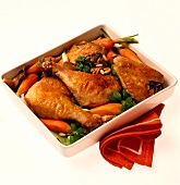 Braised chicken pieces with carrots, oyster, mushrooms and pine nuts on serving tray