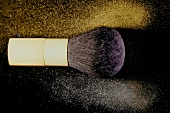 Close-up of make-up blush with gold and silver powder