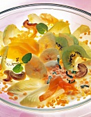 Salad with chicory, banana and kiwi on glass plate