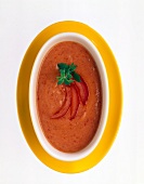 Tomato sauce garnished with tomato slices and herbs on serving dish