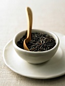 Close-up of wild rice with wooden spoon in bowl kept