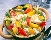 Gratin of fish fillet with vegetables in pot