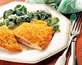 Turkey breast fillet with cheese, broccoli and ham on plate