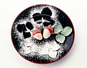 Strawberry desert with white chocolate, sugar powder and leaves